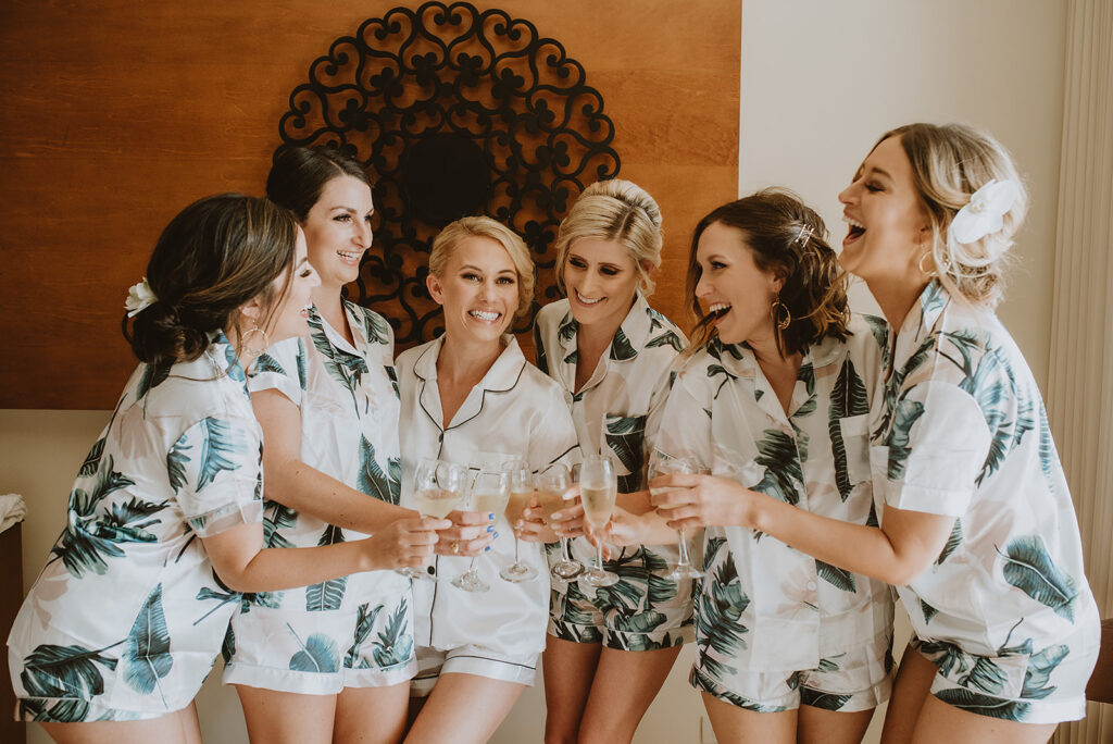 bride and bridesmaids toasting